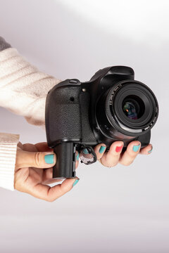 Installing a rechargeable battery into a digital camera with copy space, vertical