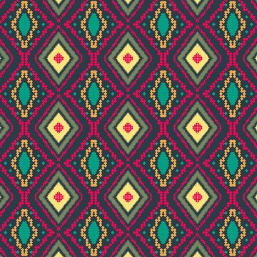 Ethnic ikat seamless pattern with pixelated diamond tribal motifs on dark background
