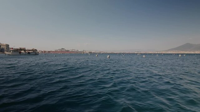 A boat harvesting mussels from a farm in the Gulf of Naples along the Mediterranean coast.