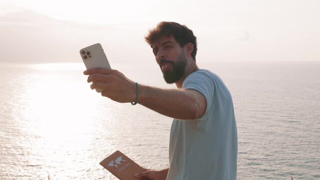 Influencer taking a selfie at sunset by the sea
