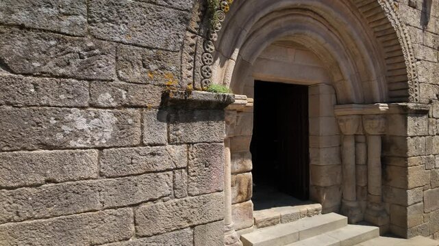 Woman entering the romanesque church of San Martino de Pazo in Allariz