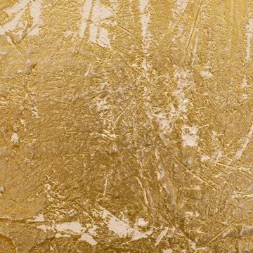 Close-up view of a golden textured Venetian plaster surface showcasing intricate patterns and shimmering highlights, ideal for backgrounds, design inspiration, or adding an elegant touch to visual pro