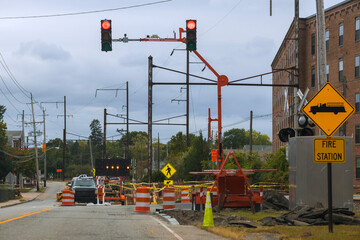 Workers manage traffic equipment for road repairs close to fire station, © ungvar