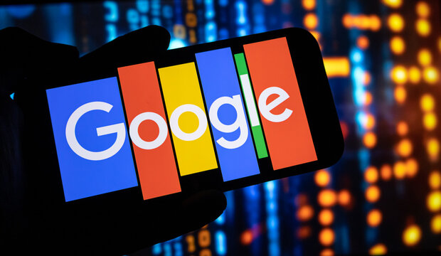 A close up of a hand holding an iphone with google logo on screen against blurred background of binary code.