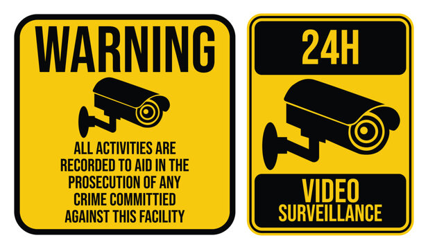 Security camera signs with yellow backgrounds and bold black text warning of video surveillance alert