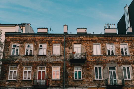 Authentic prewar residential tenement building in the historic Praga district of Warsaw, showcasing raw urban architecture and local neighborhood atmosphere.