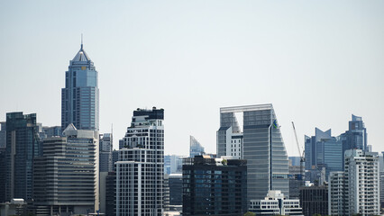 Fototapeta premium Modern city skyline with high rise skyscrapers and modern architecture under clear sky, business district concept