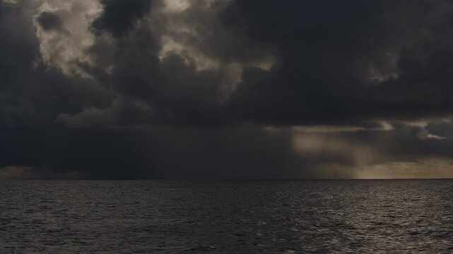 Dark Atlantic Ocean and stormy clouds as seen from the moving sailing boat
