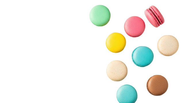 Colorful pastel french macarons and sprinkles artfully scattered on a white background with copy space. Premium confectionery advertising concept