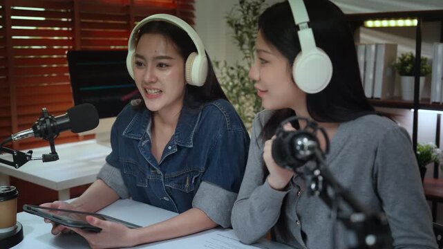 Podcast podcaster influencer creator content live stream recording studio microphone headphone two female hosts in home studio, conversation sharing ideas, creative teamwork shaping podcast flow