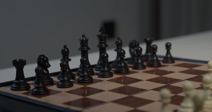 close up of chess pieces being moved during a game