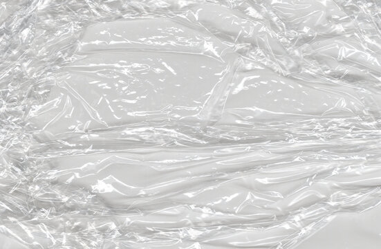 Glossy wrinkles scatter sharp crinkled highlights through a reflective sheet whose folded surface supplies luminous reference for tonal painting transparent overlays and layered material experiments