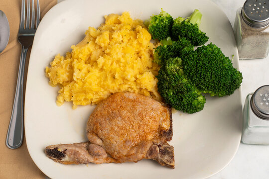 pork chop with chedder mash potatoes and broccoli