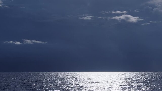 Dark Atlantic Ocean and stormy clouds as seen from the moving sailing boat