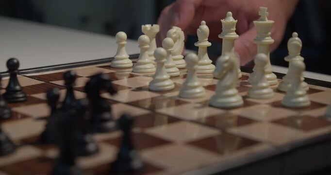 close up of chess pieces being moved during a game
