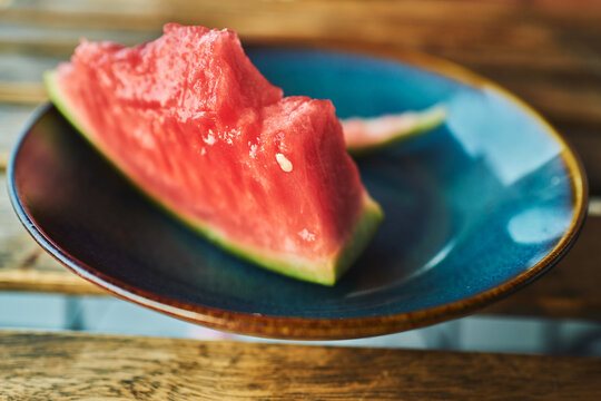 Watermelon wedges on a blue ceramic plate