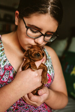 Preteen Girl Kissing Tiny Puppy