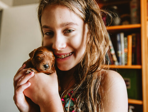 Girl Holding Newborn Puppy