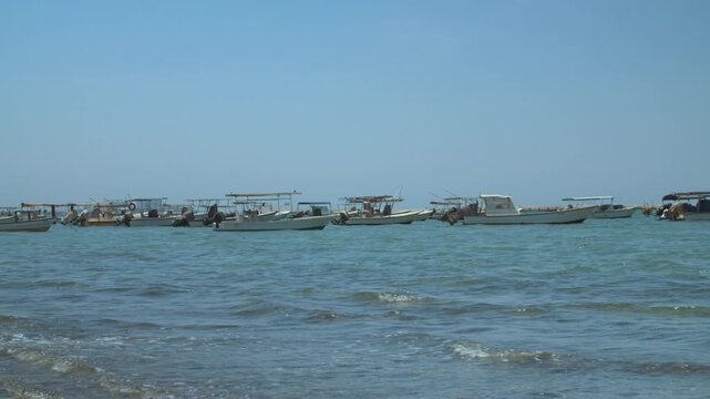 Fishing boats anchored at a dirty beach on a windy day