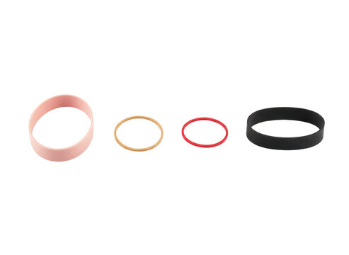 Four different colorful elastic rubber bands arranged in a row