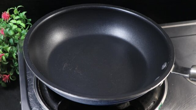 Empty clean non-stick frying pan on a gas stove in the kitchen
