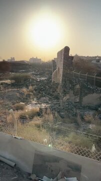Ancient stone ruins and historic architecture at a heritage site during sunset.