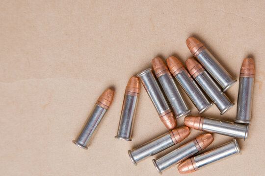 Group of 7.62 mm bullets on brown paper background with copy space