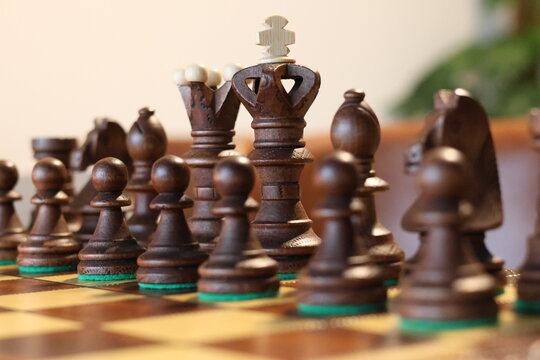 Wooden Chess Pieces on Chess Board with King in focus Strategy and Intelligence concept