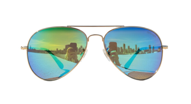 Gold aviator sunglasses with a mirrored city skyline reflection on a minimalist concrete background. Concept of modern aspiration and future vision