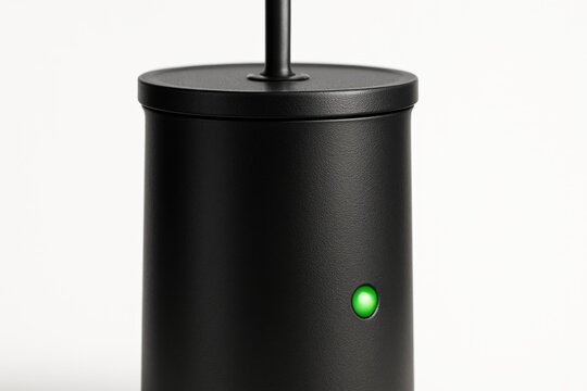 Device with a green light and simple design on a white background