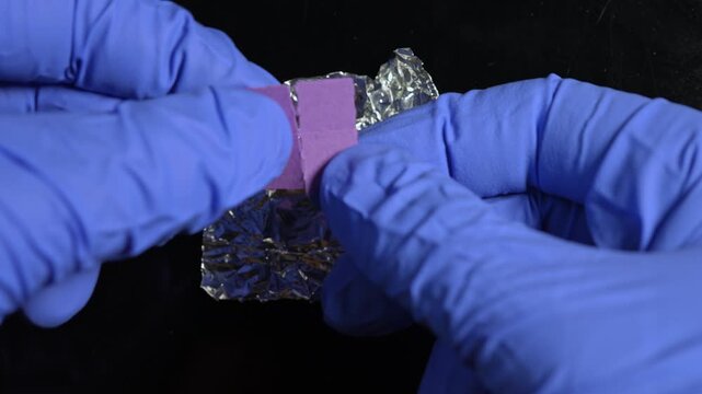 Forensic in blue gloves examination LSD acid confiscation. Laboratory set police investigator. Seized illegal drugs. Forensic science criminalist. Crime scene hallucinogenic substance evidence.