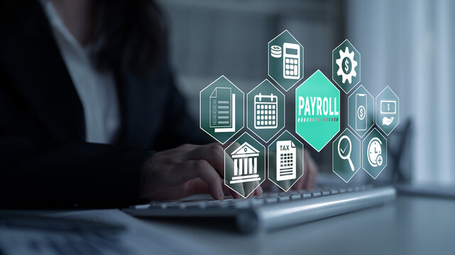 Business Professional Working on Payroll Management with Digital Icons and Symbols Overlaid on Laptop Keyboard in Modern Office Environment Fluxor.