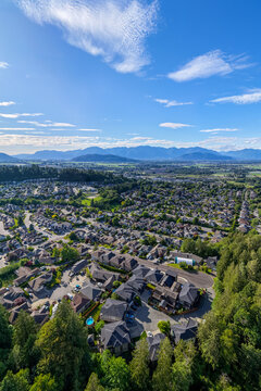 Aerial View Of Suburban Neighborhood Overlooking Mountains In Fraser Valley, Chilliwack, British Columbia, Canada
