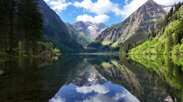 Scenic nature view over mountain lake. Reflective lake with mountain landscape. Landscape of mountain peak and valley lake. Nature landscape. Lake in wild nature forest scenery. Mountain reflection