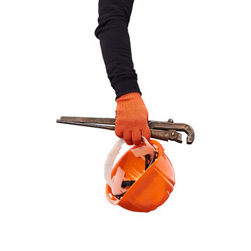 Construction worker hand holding pipe wrench and orange safety helmet isolated PNG on transparent background, protective equipment and plumbing tools