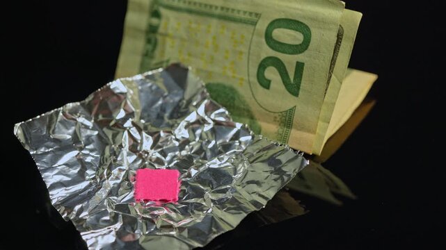 LSD acid wrapped in aluminum foil for storage and transportation. LSD usually distributed on small pieces of blotter paper. Dealers use foil as protective wrap. LSD possession distribution is illegal.