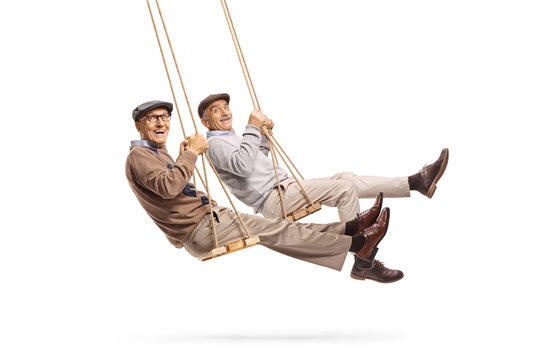 Happy elderly men swinging on a swing