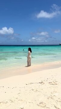 Woman walking towards the camera on tropical Klein Cura&ccedil;ao beach