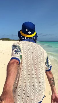 Man leading his girlfriend on a Cura&ccedil;ao beach in Klein island