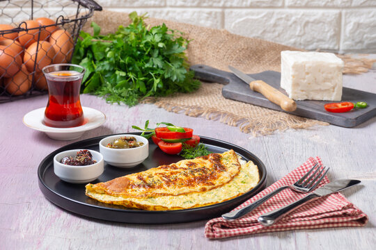Traditional Turkish Omelet Breakfast Table with Black Tea and Fresh Ingredients