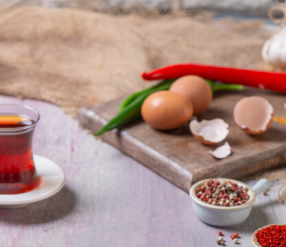 Out of focus image of Turkish Black Tea with Fresh Eggs and Spices Preparation for Breakfast