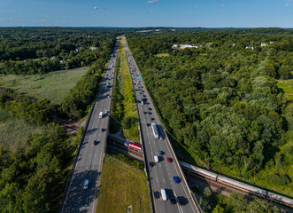 Fototapeta premium Aerial view of interstate 495 and the commuter rail on a late summer afternoon. -Littleton, Massachusetts 
