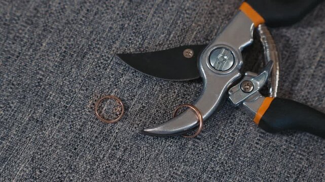 Relationship conflict symbol rings and cutting tool convey tension and union breakup