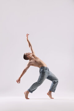 Professional dancer practicing moves on white background