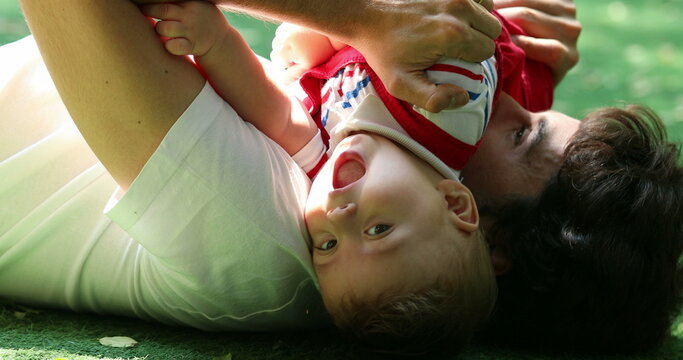 Candid authentic father and infant baby loving interaction relationship outside