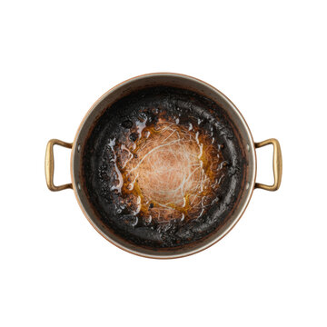 Top view of a round vintage copper pot with burnt carbonized food residue and scratches on a white studio background concept of domestic cleaning maintenance
