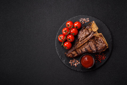 T-bone steak, beef meat grilled until done rare with salt and spices. T-bone steak
