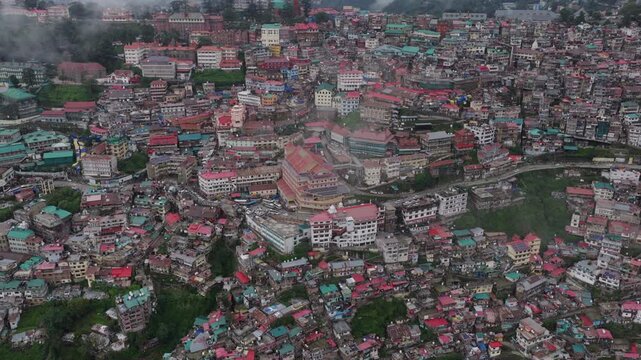 Oblique aerial view of Shimla city buildings with commercial district and residential neighborhoods.