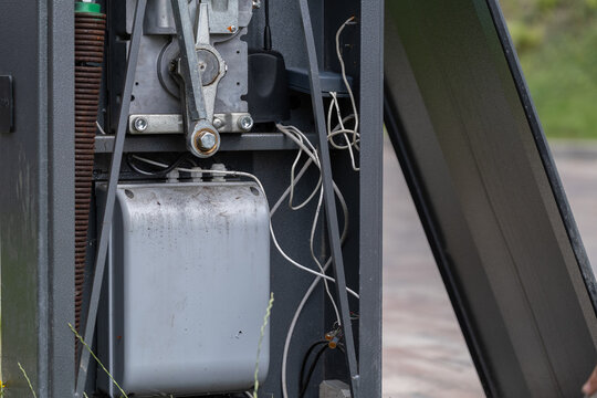 Close-up of industrial electromechanical equipment with exposed mechanical components and wiring