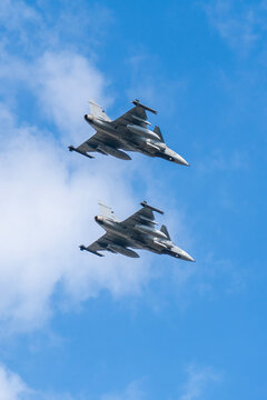 Hungarian gray fighter jets flying in formation in the blue sky